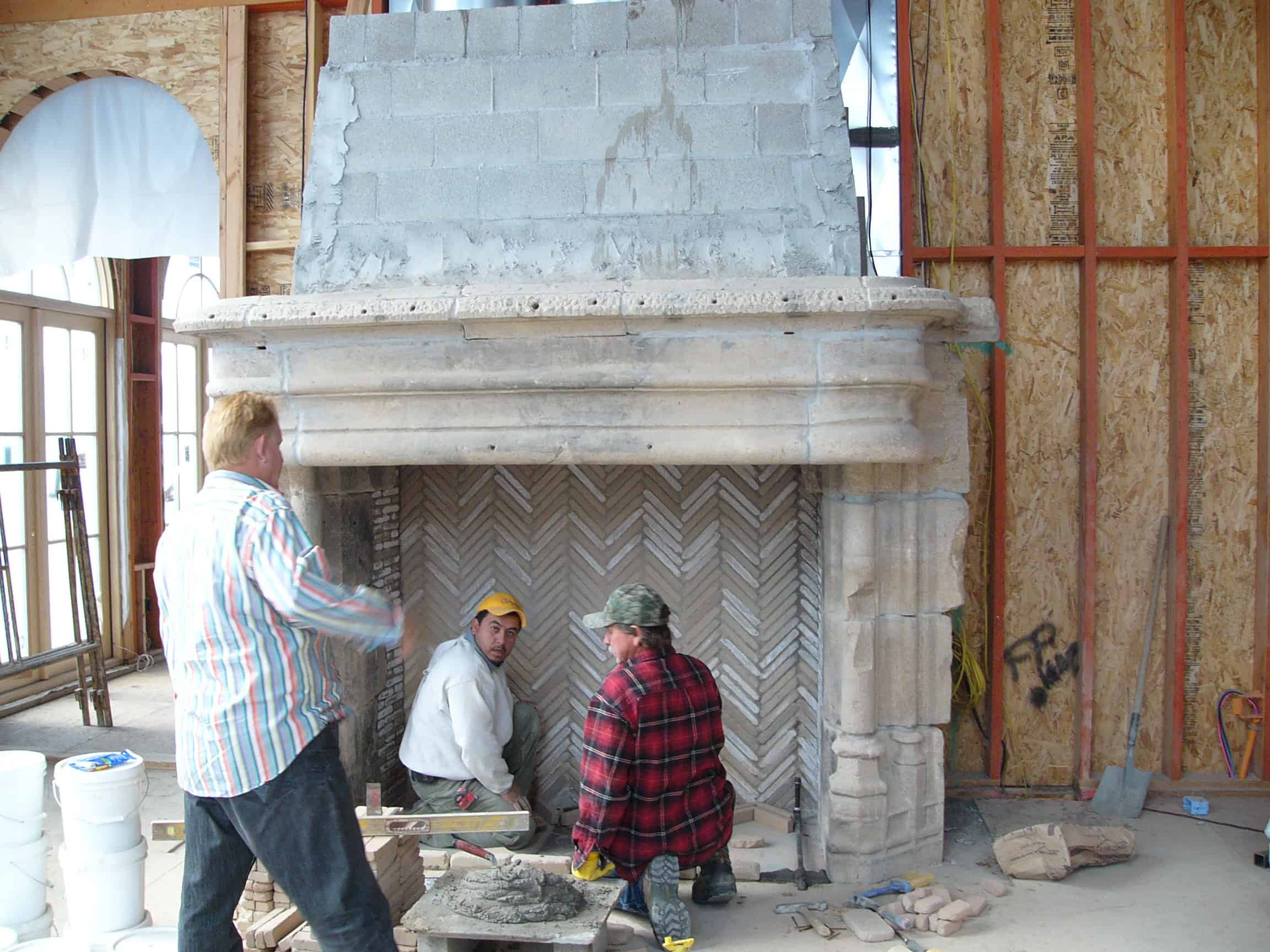 Fireplace installation in progress using reclaimed clay tiles